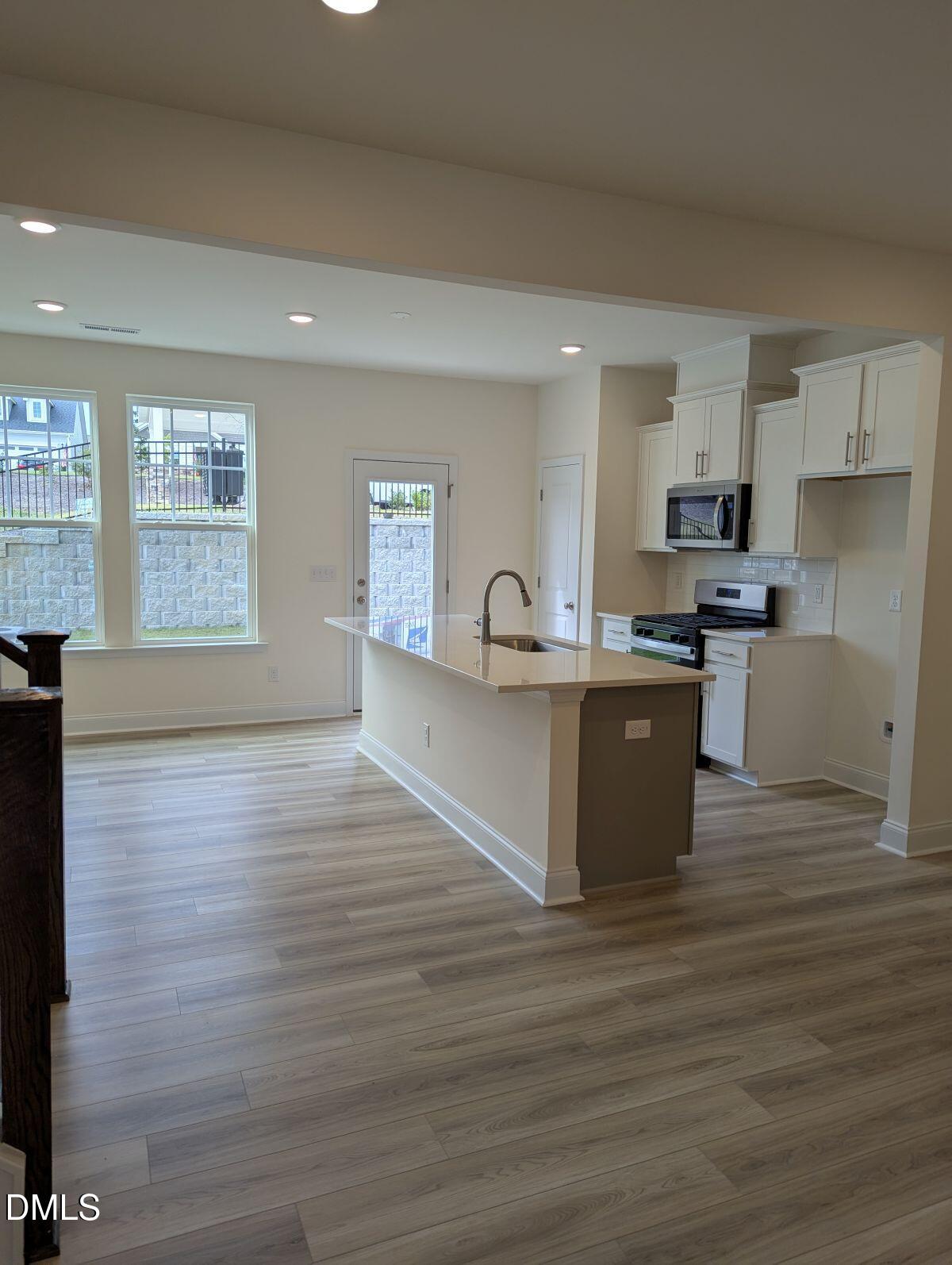908 Kensley Grv Lane Fuquay-Varina, NC 27526 - Photo 13 of 37 a view of kitchen and sink with wooden floor