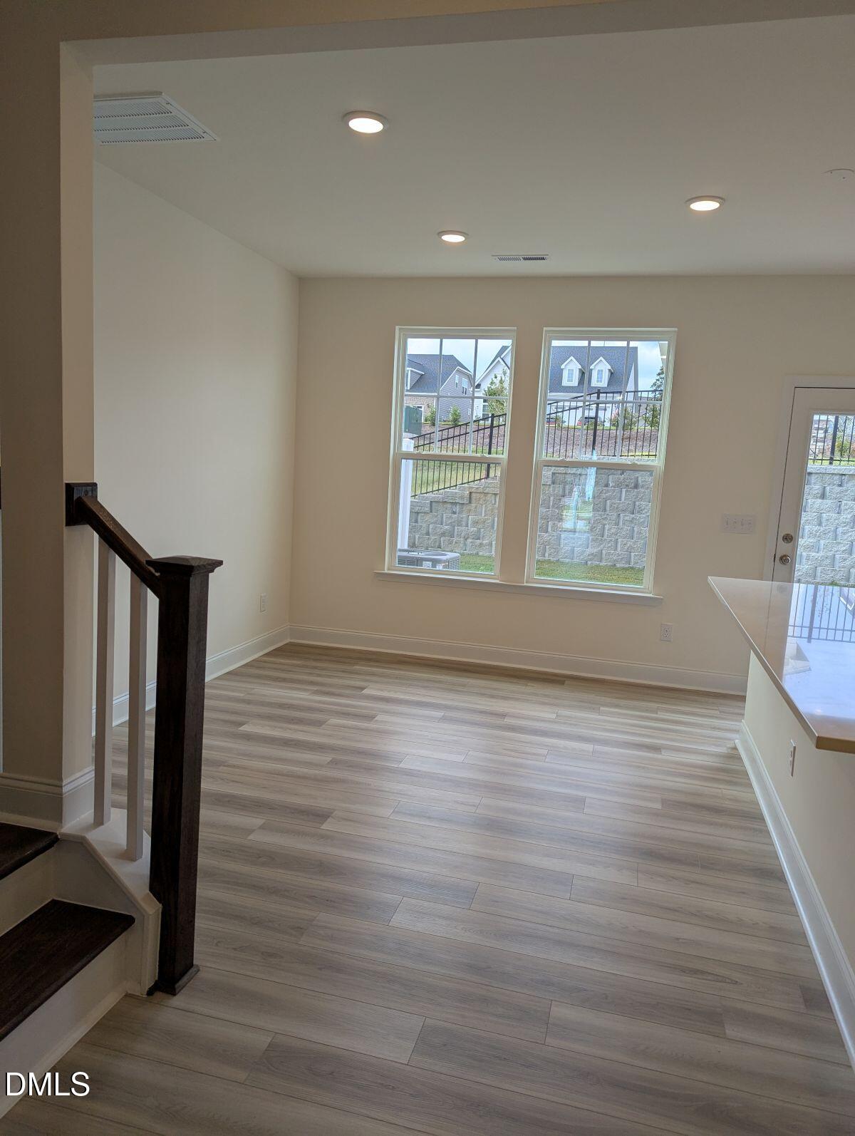 908 Kensley Grv Lane Fuquay-Varina, NC 27526 - Photo 16 of 37 a view of an empty room with wooden floor and a window