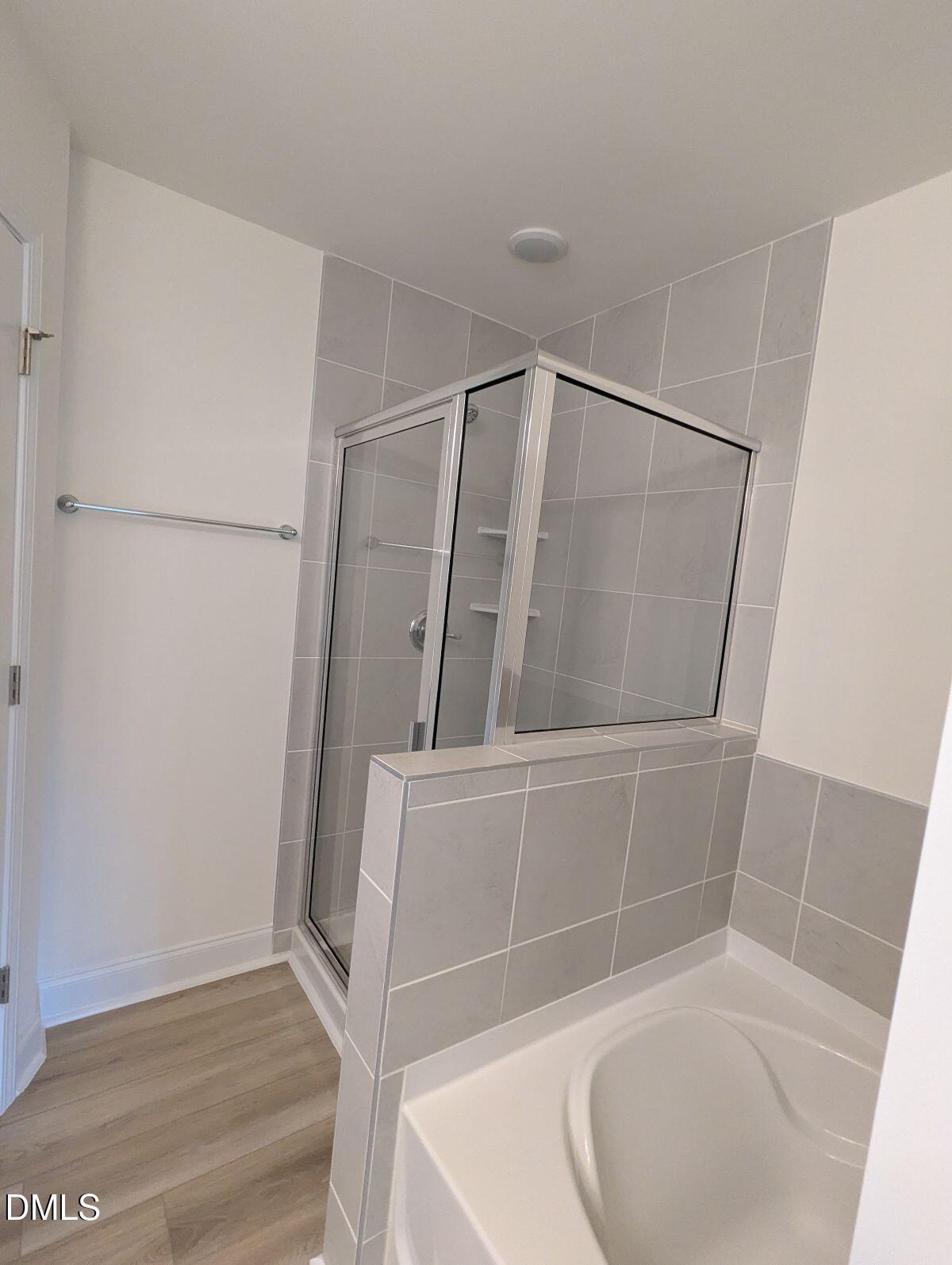 908 Kensley Grv Lane Fuquay-Varina, NC 27526 - Photo 23 of 37 a bathroom with a glass door shower