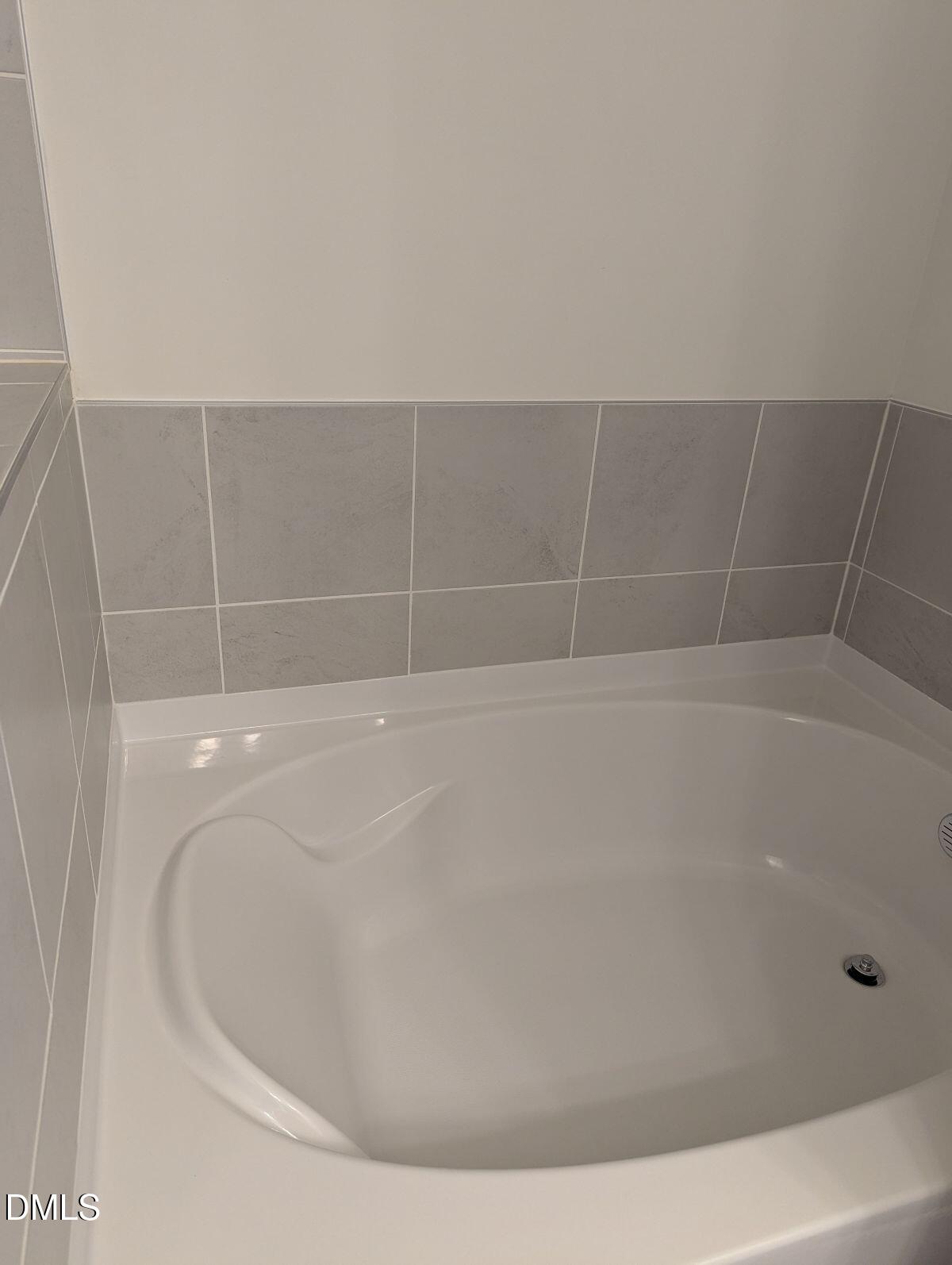 908 Kensley Grv Lane Fuquay-Varina, NC 27526 - Photo 24 of 37 a close up of a bathtub