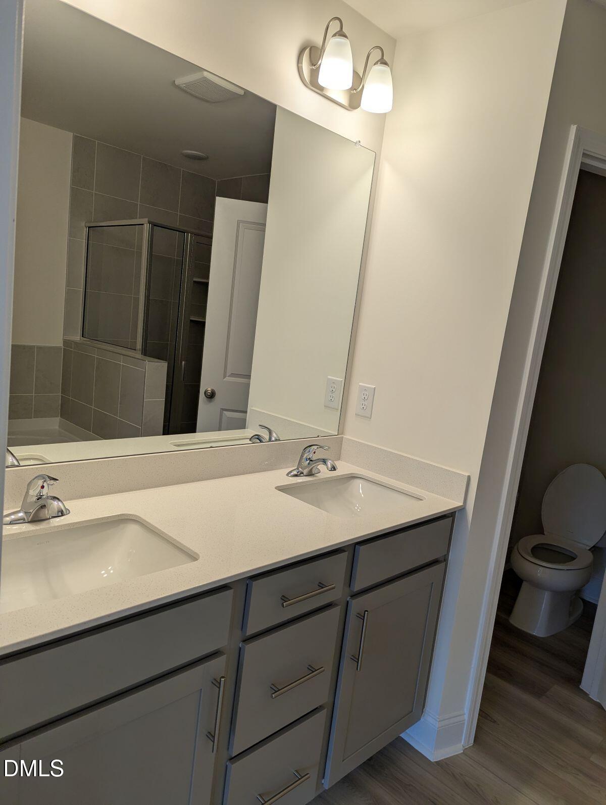 908 Kensley Grv Lane Fuquay-Varina, NC 27526 - Photo 25 of 37 a bathroom with a sink and a mirror