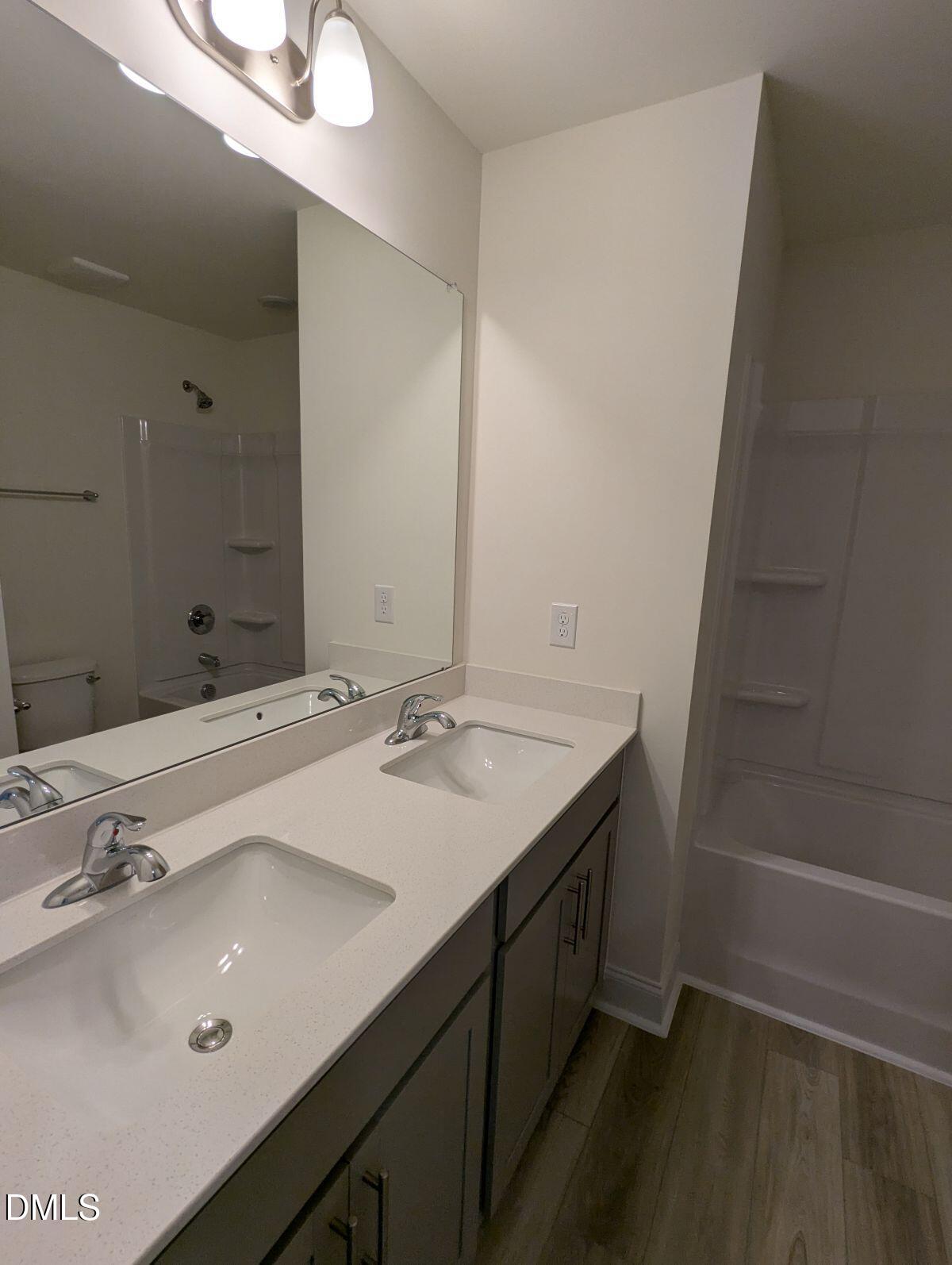 908 Kensley Grv Lane Fuquay-Varina, NC 27526 - Photo 30 of 37 a bathroom with a sink and a mirror