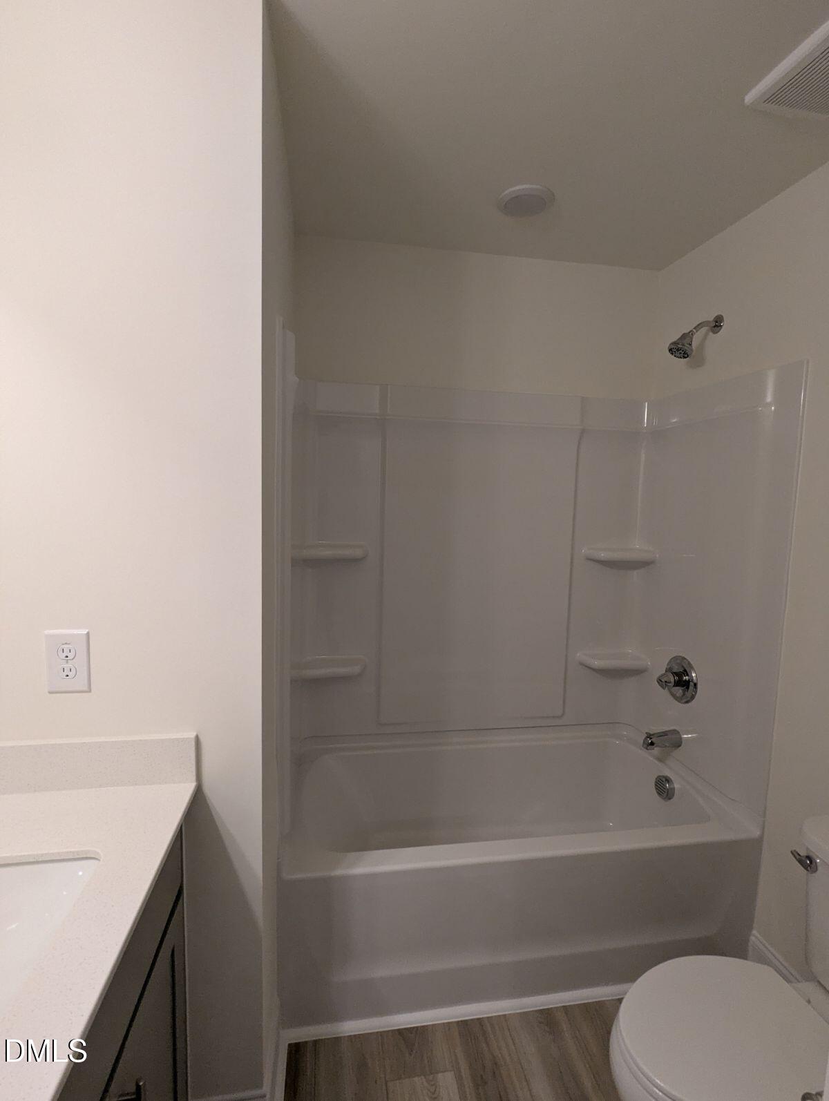 908 Kensley Grv Lane Fuquay-Varina, NC 27526 - Photo 31 of 37 a bathroom with a bathtub and a toilet