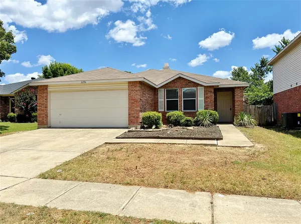 a front view of a house with a yard and a garage