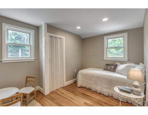 55 Cottage Road Boston, MA 02132 - Photo 16 of 30 a bedroom with a large bed and a window
