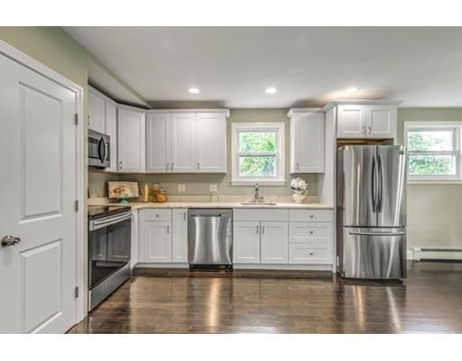 55 Cottage Road Boston, MA 02132 - Photo 5 of 30 a kitchen with granite countertop white cabinets and stainless steel appliances