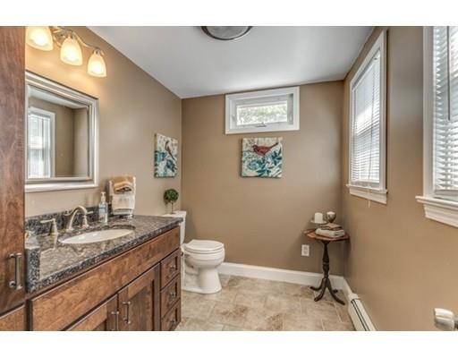 55 Cottage Road Boston, MA 02132 - Photo 10 of 30 a bathroom with a granite countertop toilet a sink and a mirror