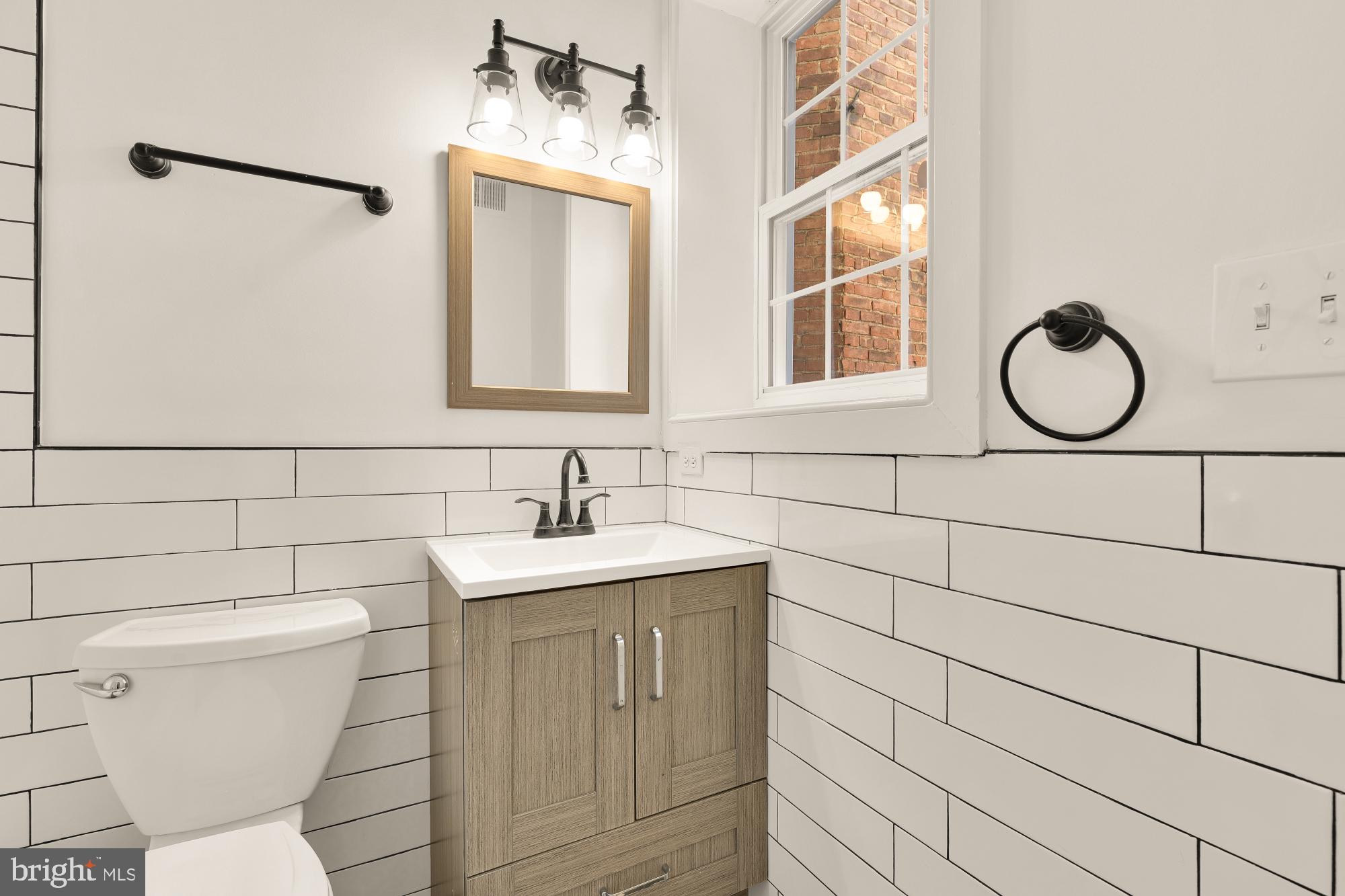 1732 North Capitol Street Northwest Washington, DC 20002 - Photo 16 of 47 a bathroom with a toilet sink and mirror