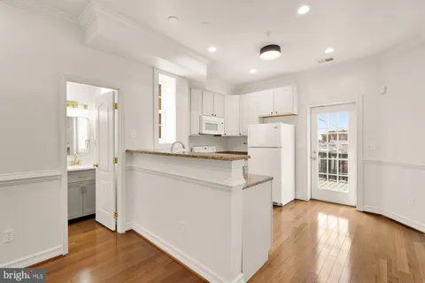 a kitchen with refrigerator and cabinets