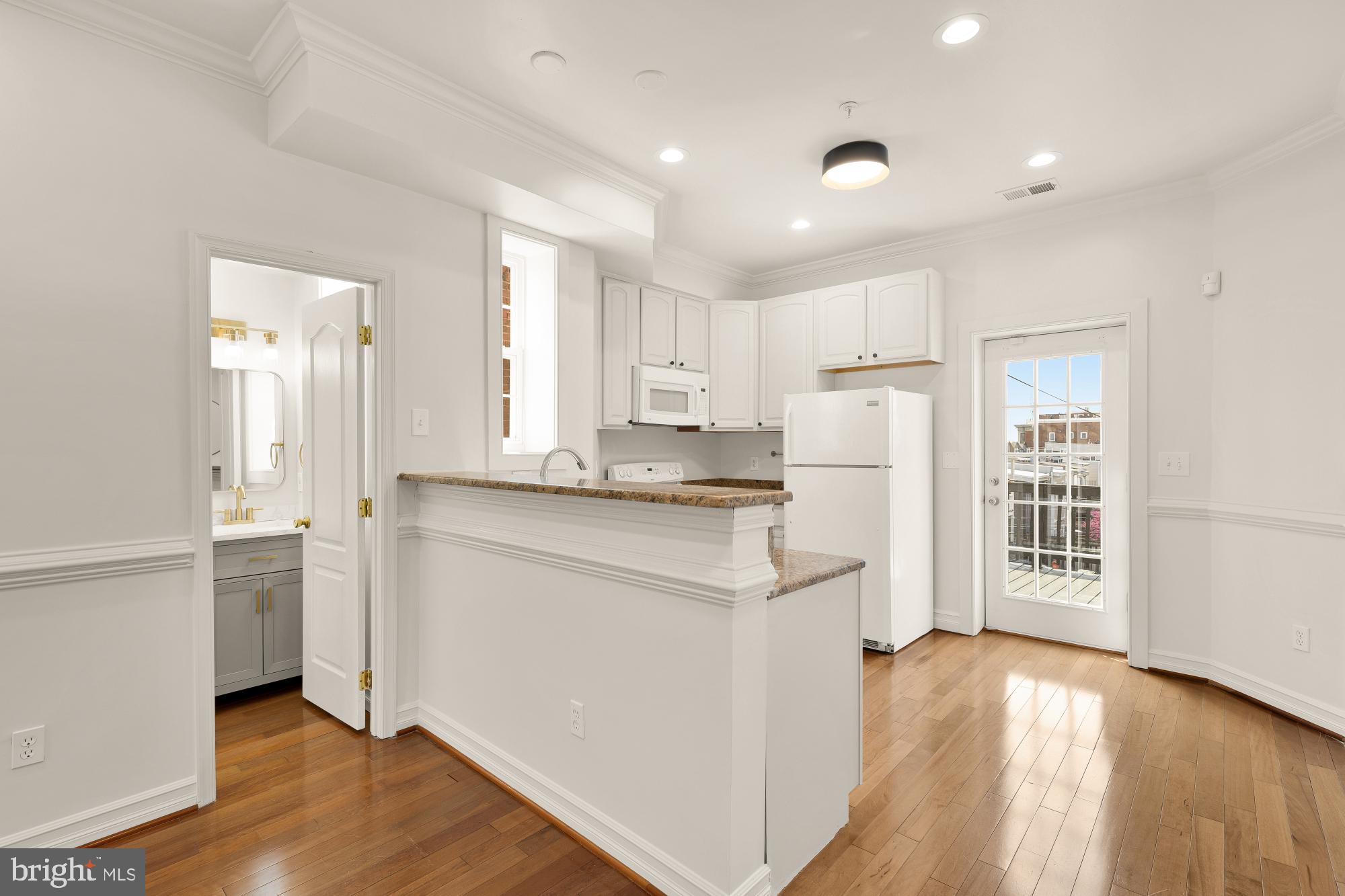 1732 North Capitol Street Northwest Washington, DC 20002 - Photo 26 of 47 a kitchen with refrigerator and cabinets