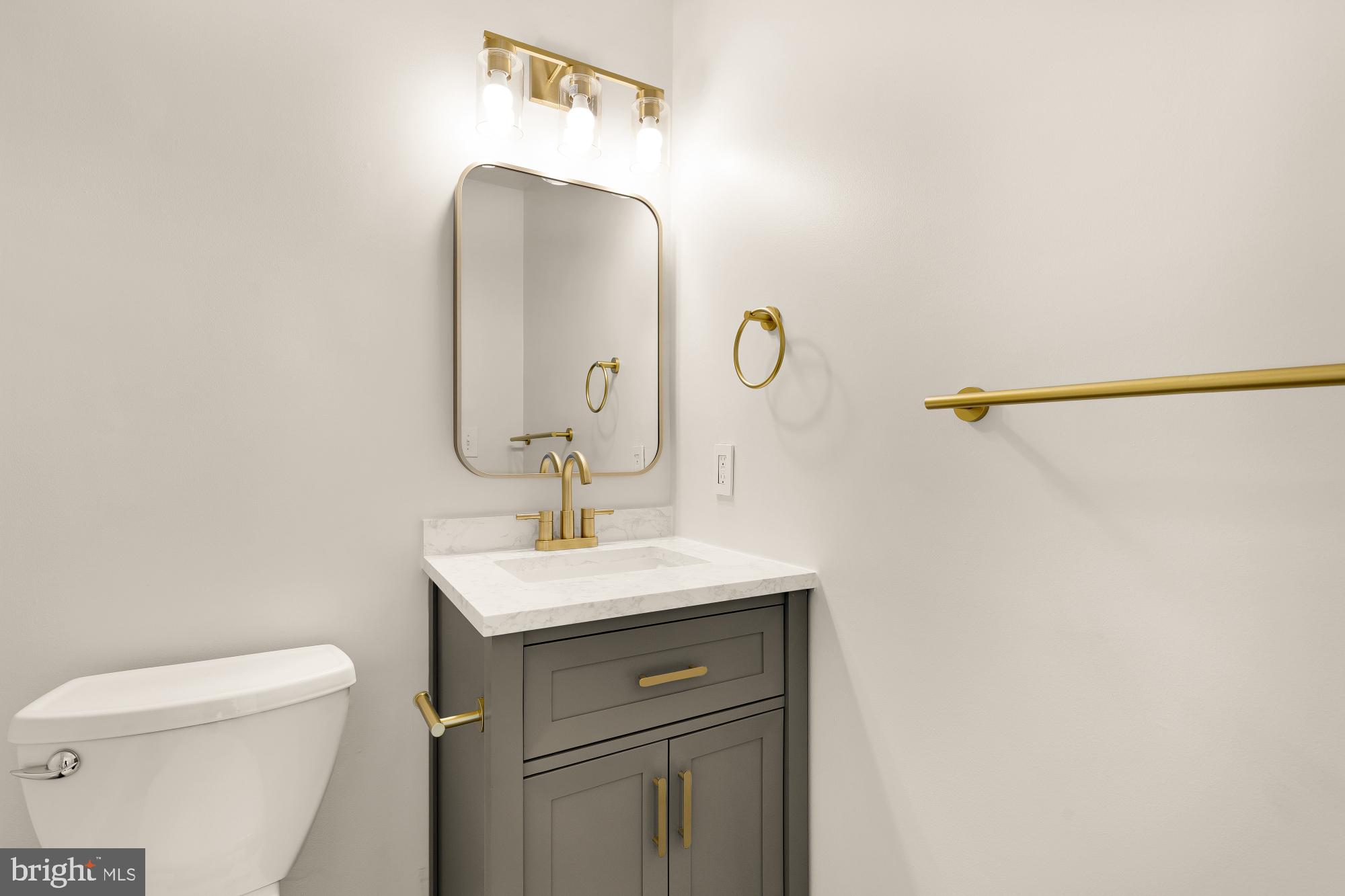 1732 North Capitol Street Northwest Washington, DC 20002 - Photo 45 of 47 a bathroom with a sink toilet and mirror