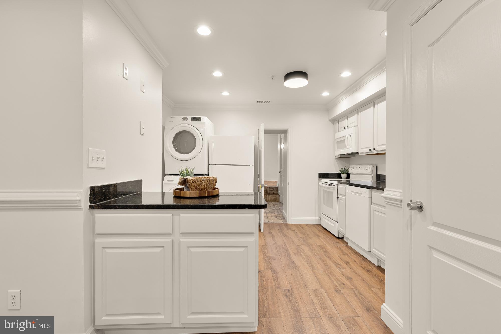 1732 North Capitol Street Northwest Washington, DC 20002 - Photo 10 of 47 a kitchen with white cabinets and stainless steel appliances