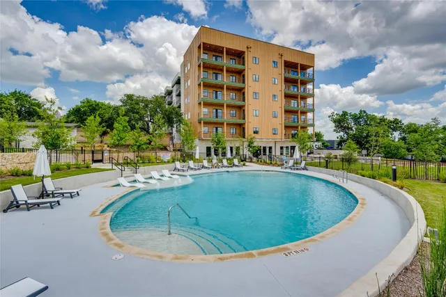 a view of swimming pool from a lounge chair