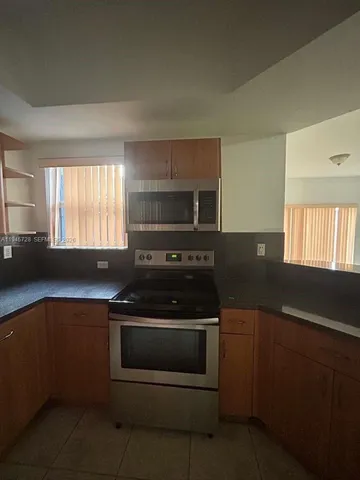 a kitchen with a stove and a sink