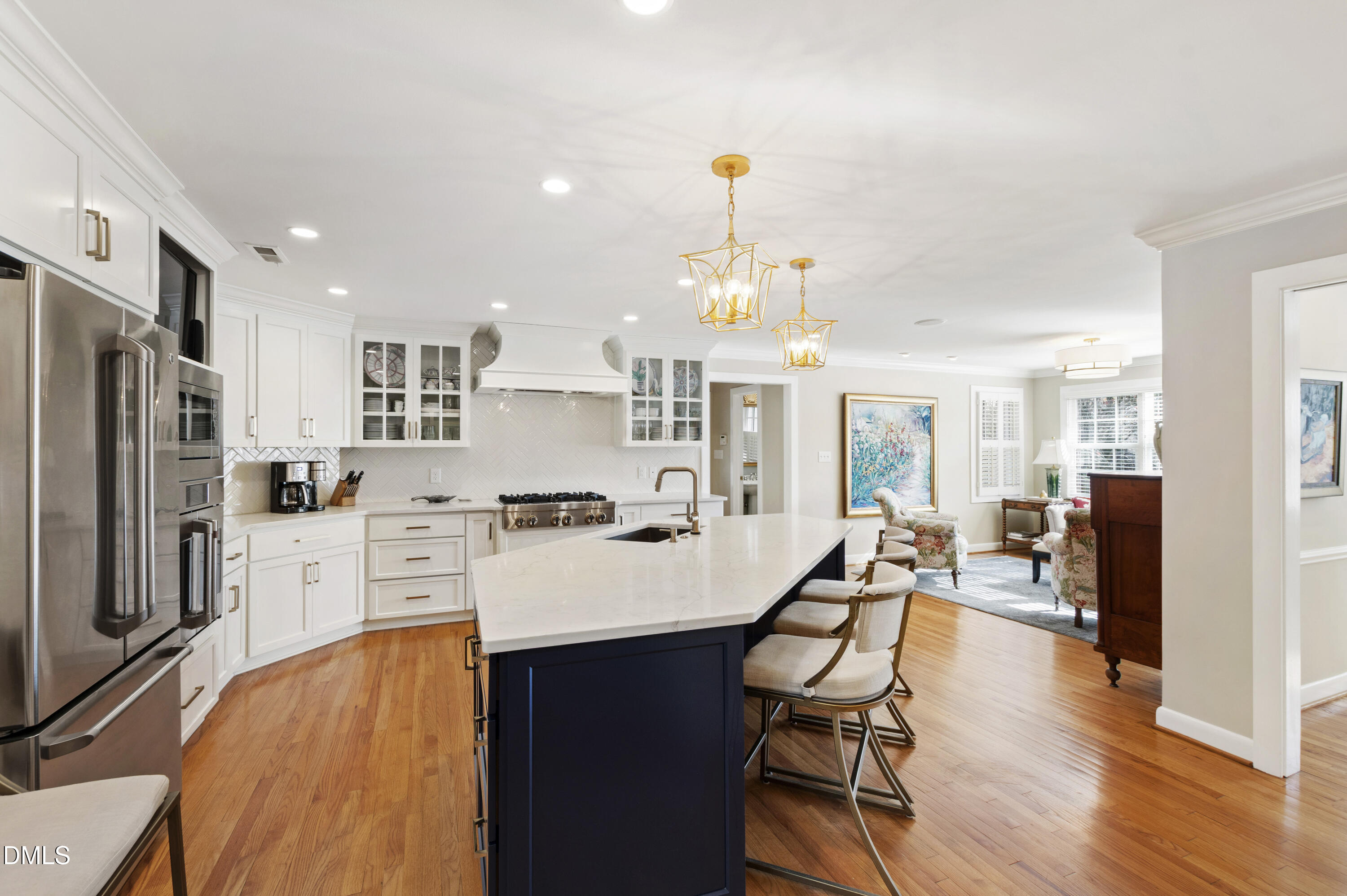 1304 Diehl Street Raleigh, NC 27608 - Photo 13 of 60 a kitchen with stainless steel appliances a dining table chairs stove and refrigerator