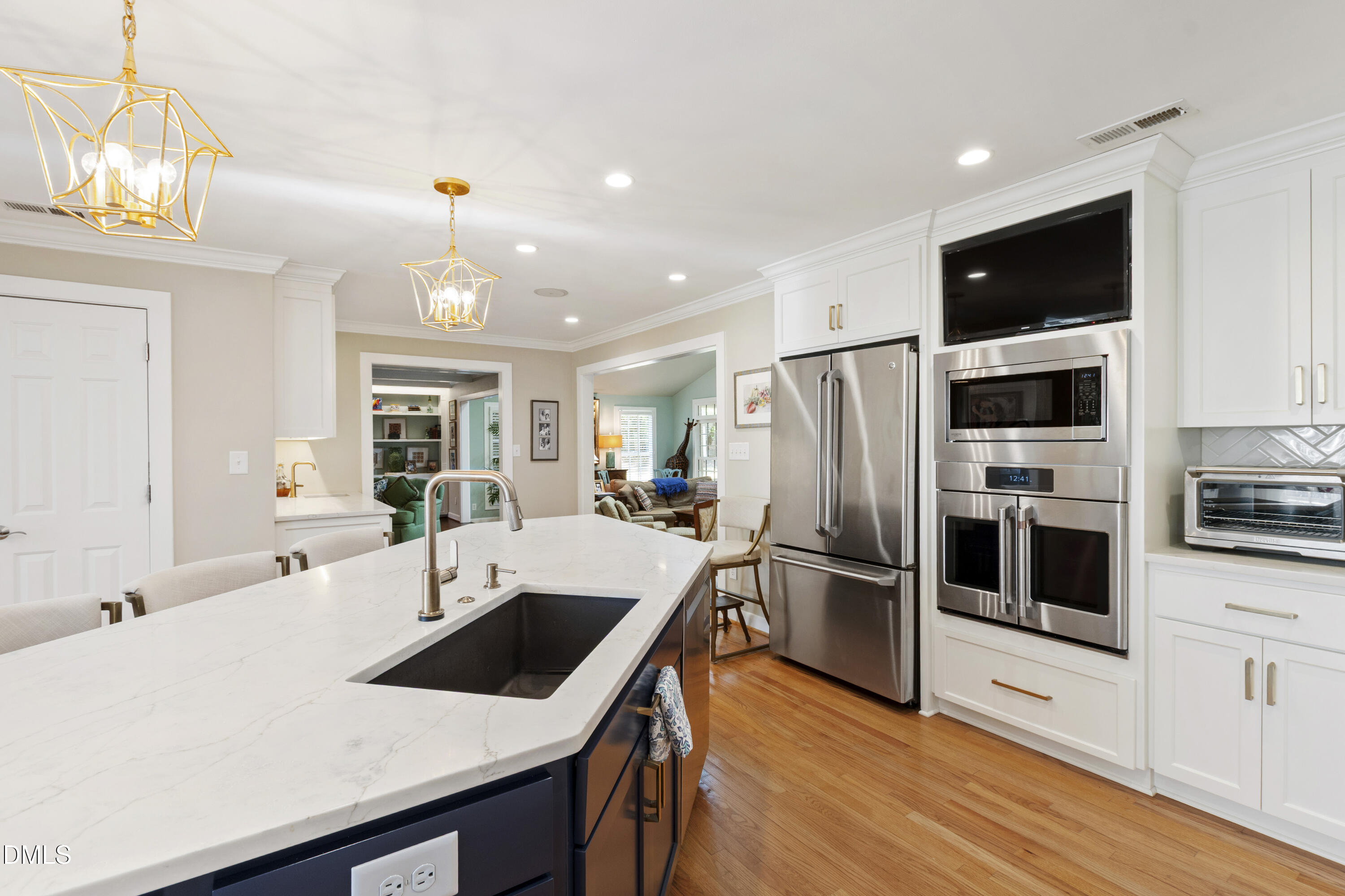 1304 Diehl Street Raleigh, NC 27608 - Photo 14 of 60 a kitchen with stainless steel appliances a stove a microwave and white cabinets