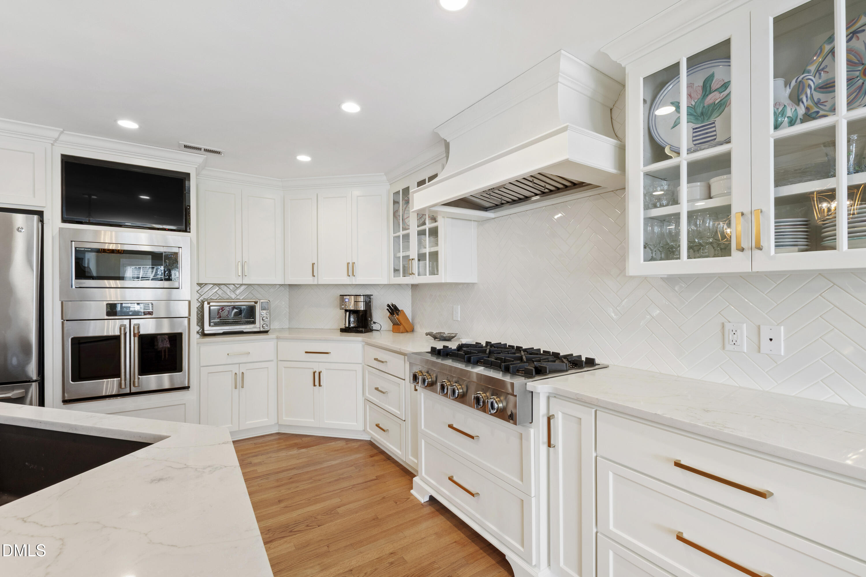 1304 Diehl Street Raleigh, NC 27608 - Photo 15 of 60 a kitchen with stainless steel appliances granite countertop a stove and a sink