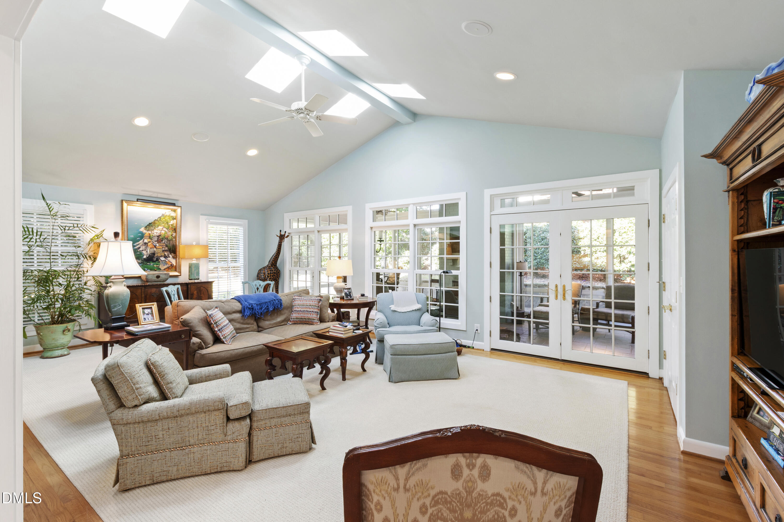 1304 Diehl Street Raleigh, NC 27608 - Photo 25 of 60 a living room with furniture a flat screen tv and a floor to ceiling window