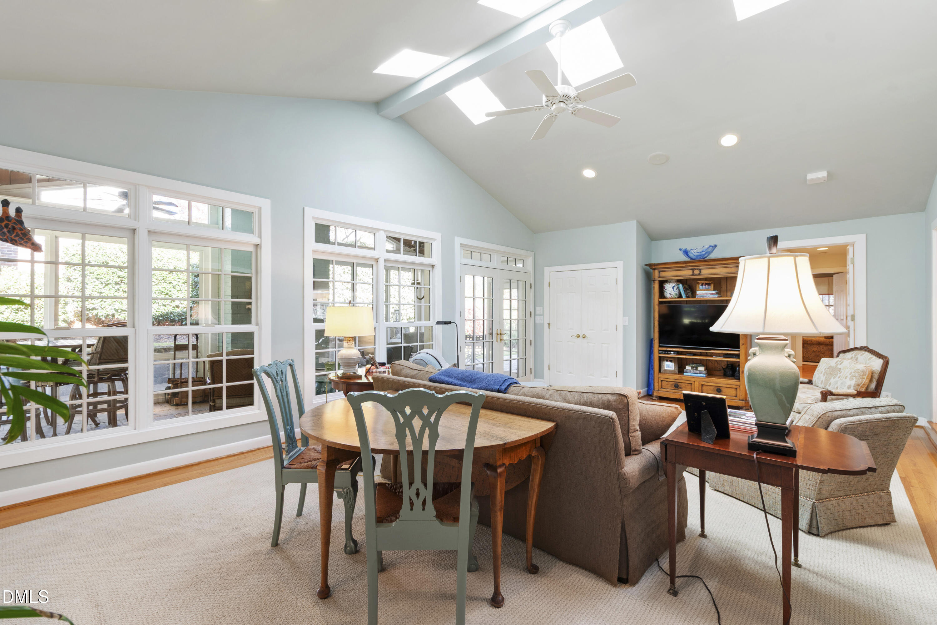 1304 Diehl Street Raleigh, NC 27608 - Photo 26 of 60 a dining room with furniture large windows and a chandelier