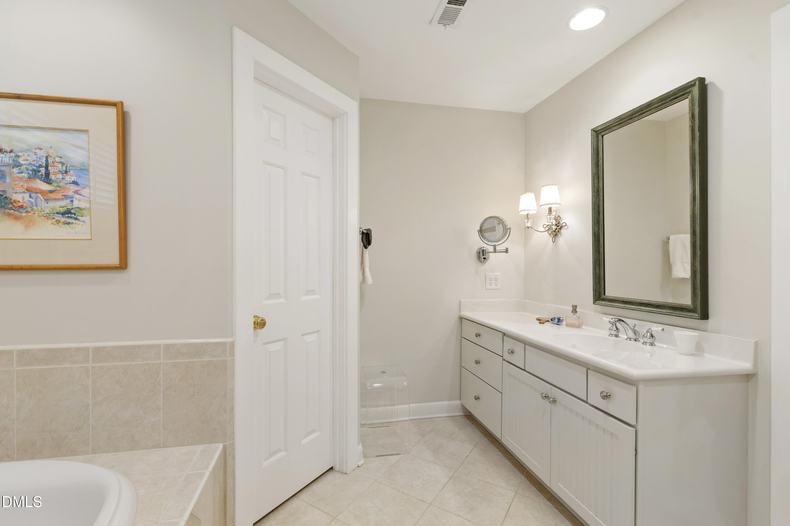 1304 Diehl Street Raleigh, NC 27608 - Photo 32 of 60 a bathroom with a double vanity sink a mirror and a bathtub