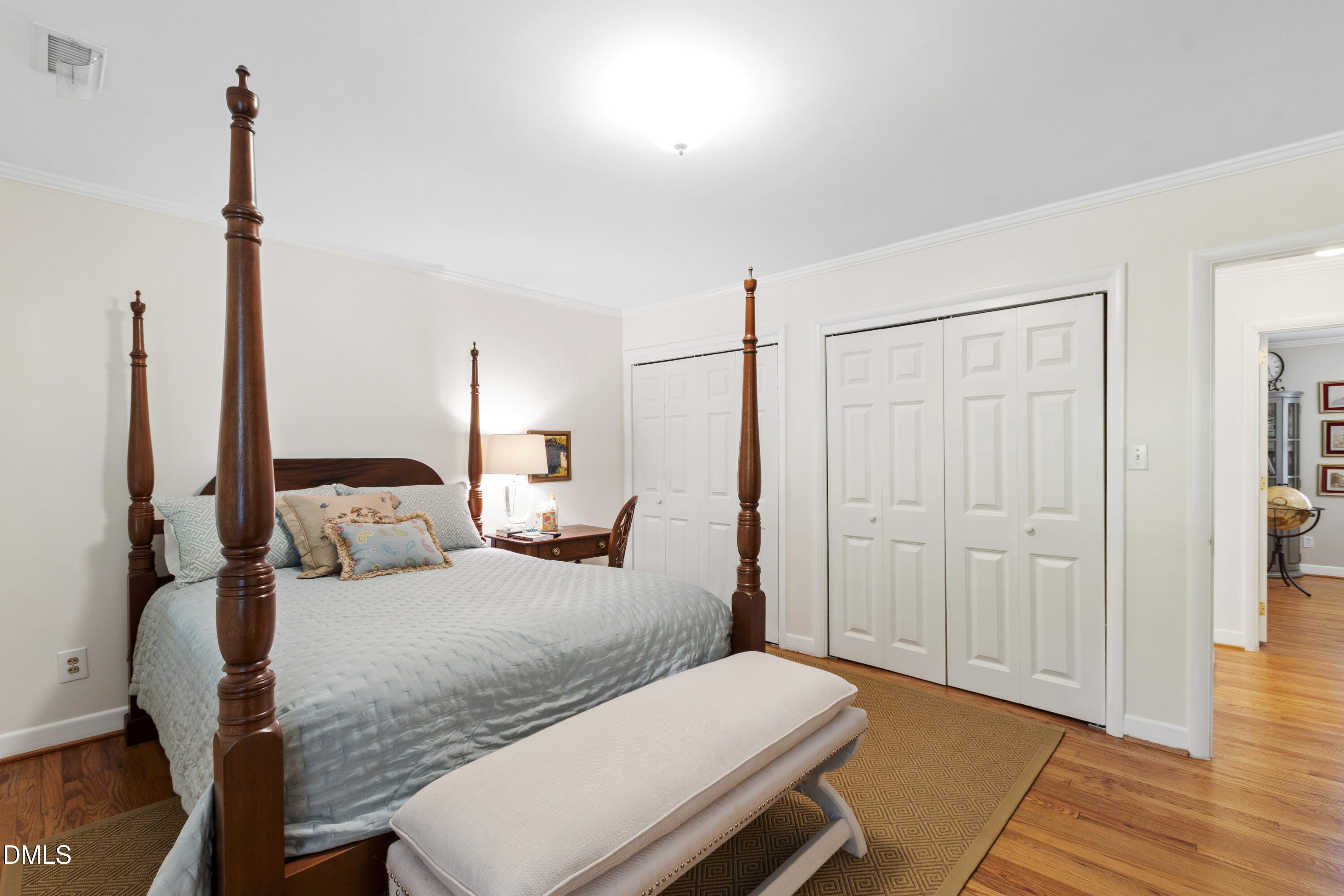 1304 Diehl Street Raleigh, NC 27608 - Photo 47 of 60 a bedroom with a bed and wooden floor