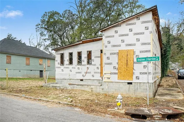 a view of a house with wooden fence