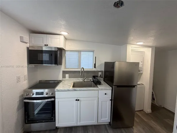 a spacious bedroom with a bed and a flat screen tv