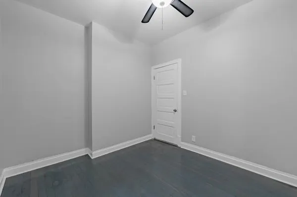 an empty room with ceiling fan