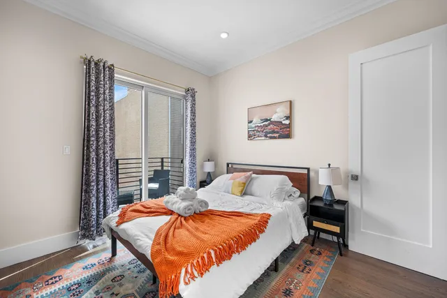 a bedroom with a bed and wooden floor