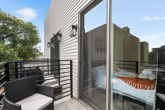 a view of a balcony with a floor to ceiling window