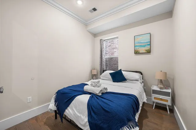 a bedroom with a bed and a table