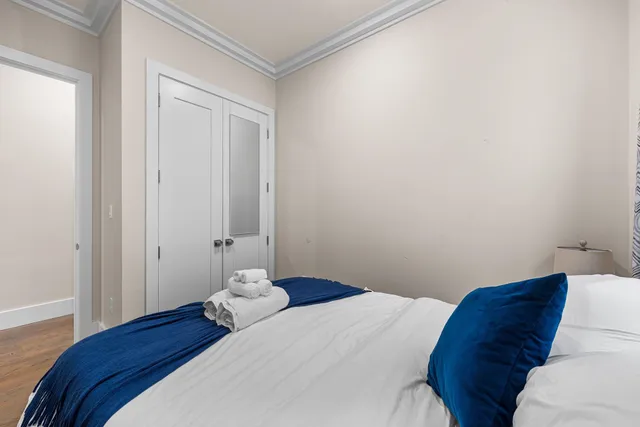 a bedroom with a bed and a closet