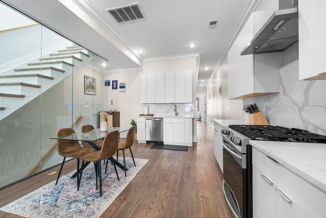 a kitchen with granite countertop kitchen island stainless steel appliances a table and chairs