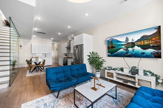 a living room with furniture and wooden floor