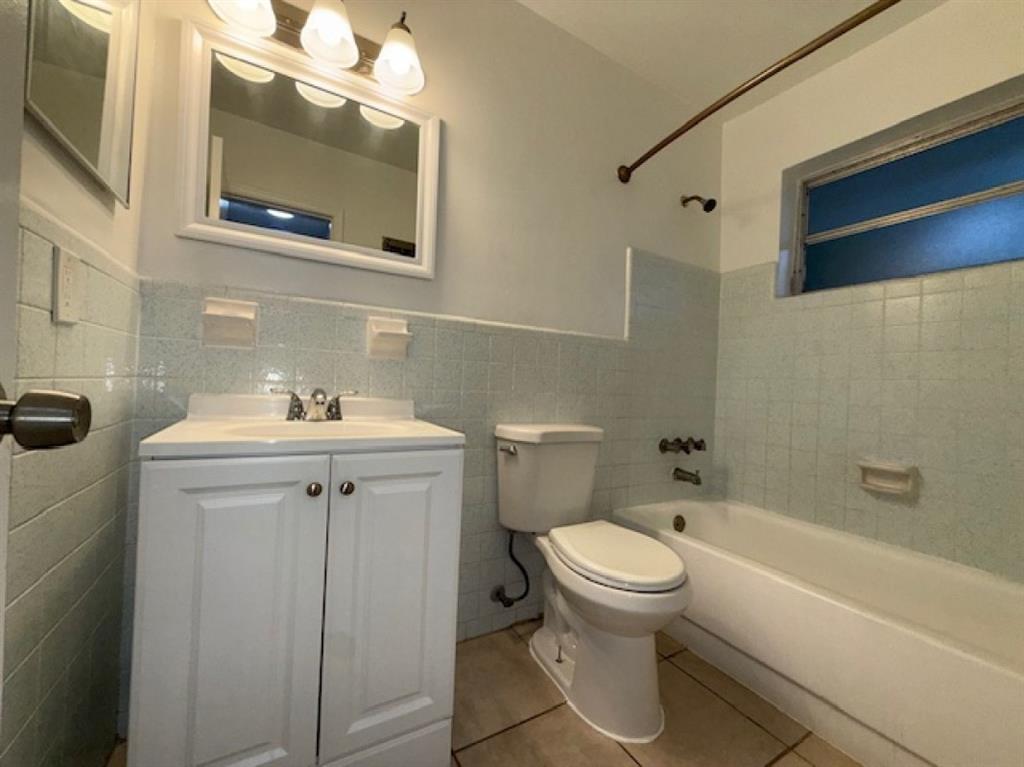 119 Northeast 5th Street, Unit 3 Pompano Beach, FL 33060 - Photo 6 of 8 a bathroom with a sink a toilet and bathtub