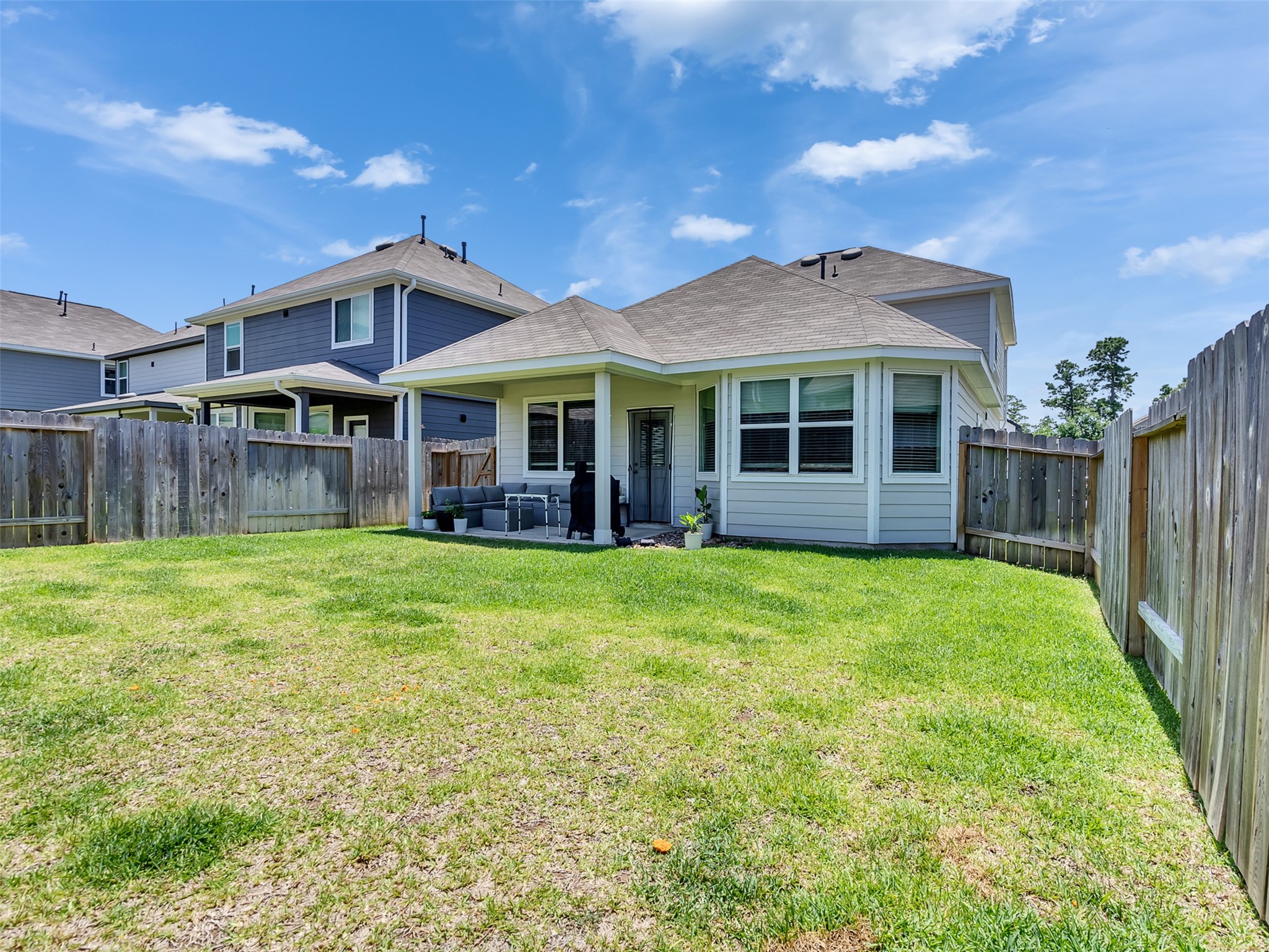 2416 Bluefish Court Conroe, TX 77384 - Photo 15 of 45 a view of a house with a backyard
