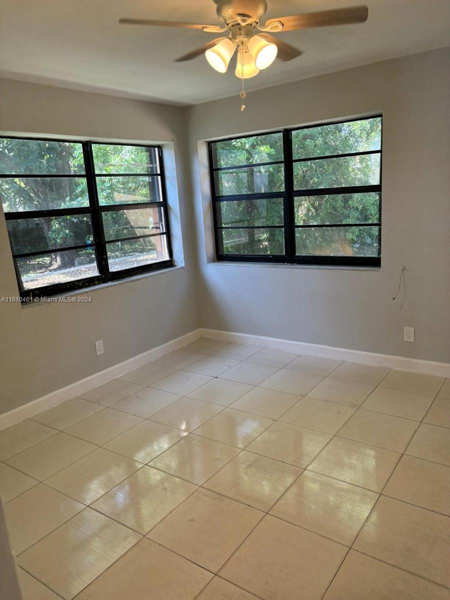 204 Southwest 2nd Place, Unit 2 Dania Beach, FL 33004 - Photo 8 of 13 an empty room with windows