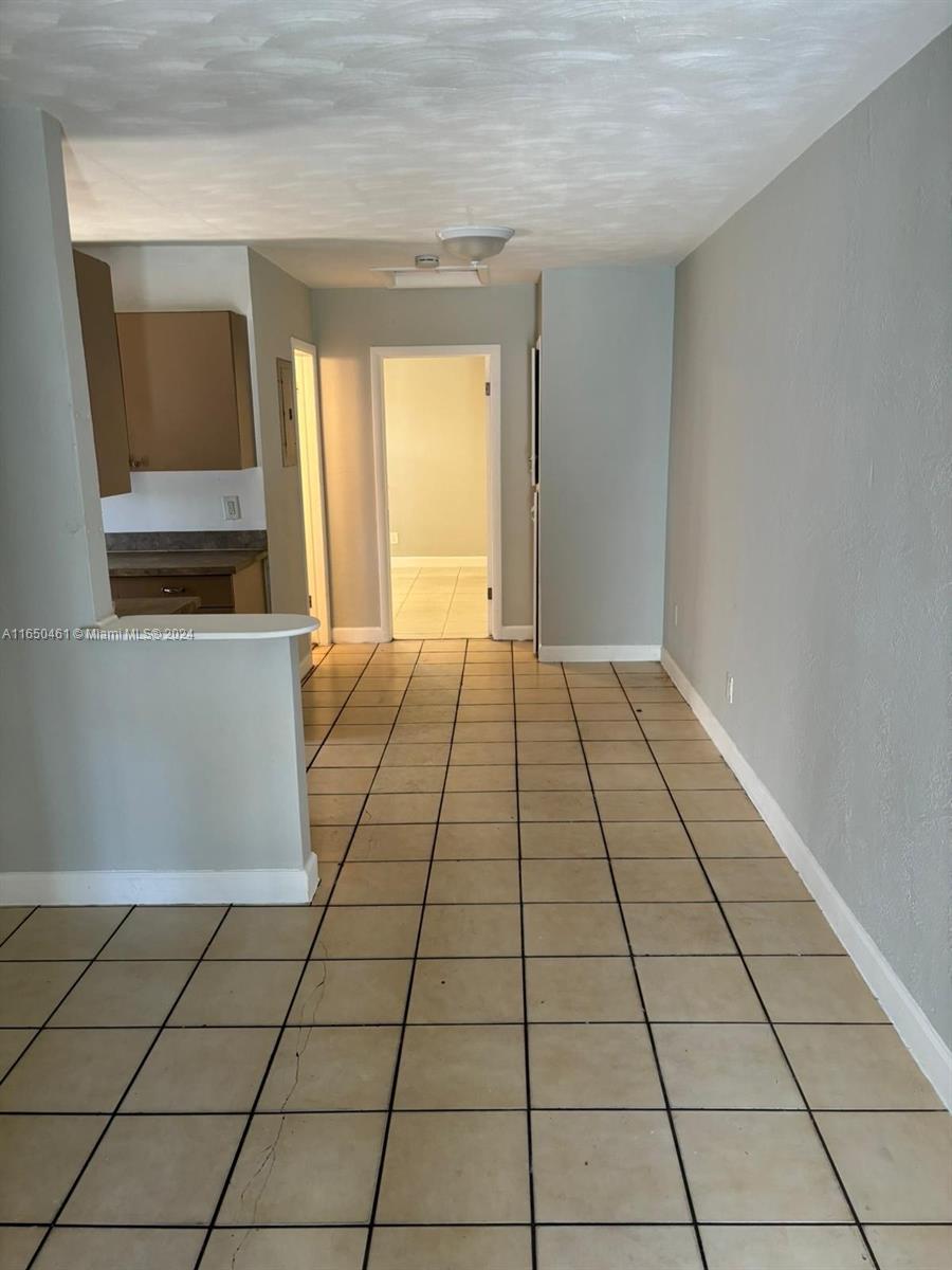 204 Southwest 2nd Place, Unit 2 Dania Beach, FL 33004 - Photo 9 of 13 a view of a livingroom with an empty space and a window