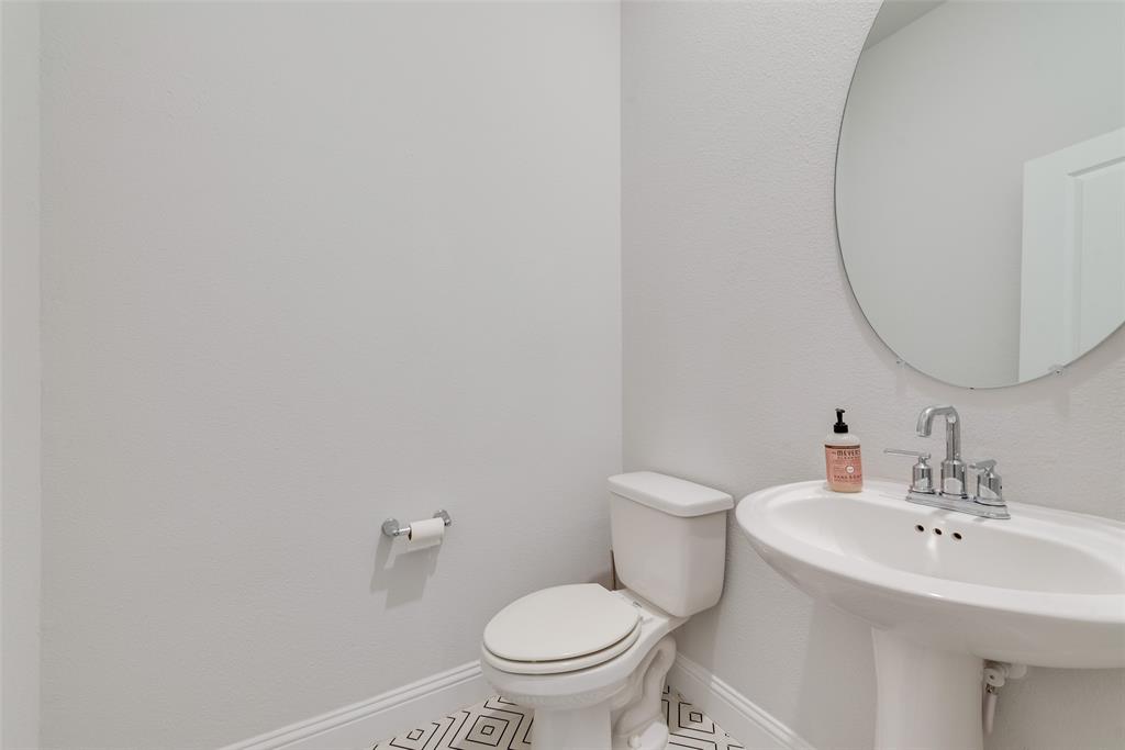 7617 Sunset Boulevard Rowlett, TX 75088 - Photo 12 of 21 Half bath with tile patterned flooring and a textured wall