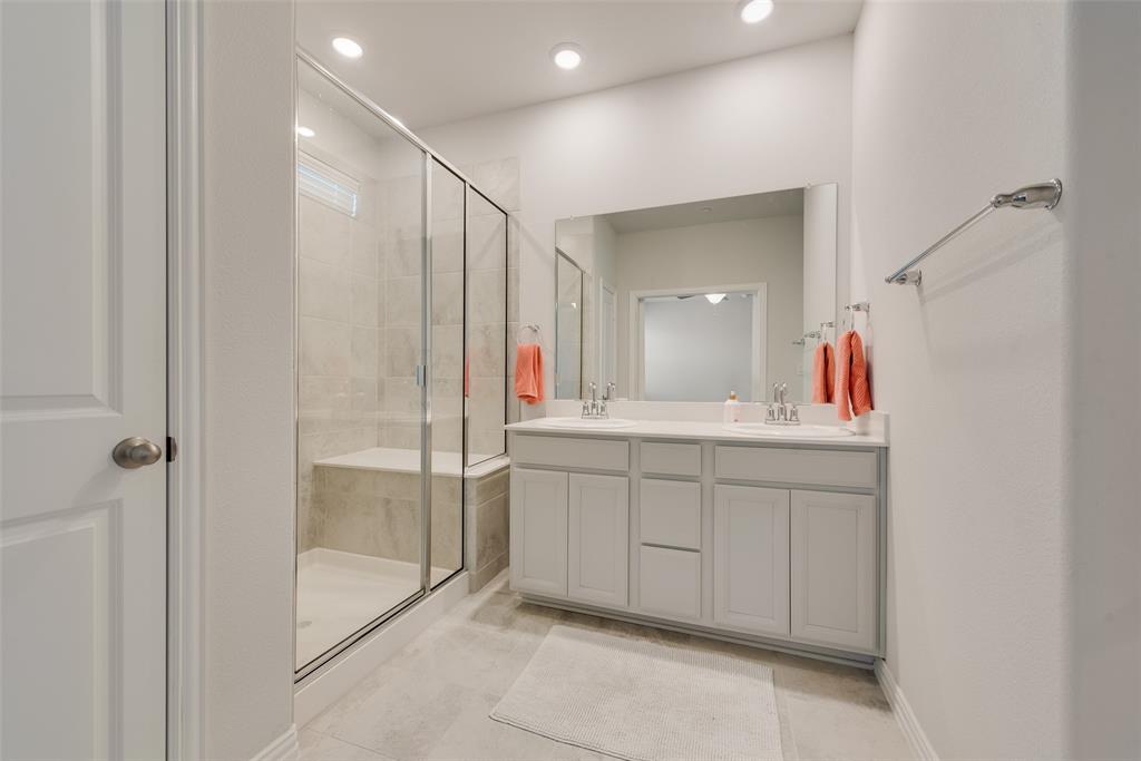 7617 Sunset Boulevard Rowlett, TX 75088 - Photo 16 of 21 Bathroom with a stall shower, double vanity, light tile patterned floors, and recessed lighting