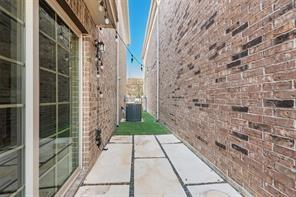 7617 Sunset Boulevard Rowlett, TX 75088 - Photo 17 of 21 View of property exterior with a patio area and brick siding