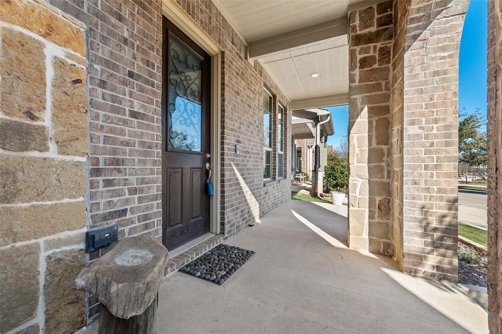 7617 Sunset Boulevard Rowlett, TX 75088 - Photo 4 of 21 View of exterior entry with a porch and brick siding