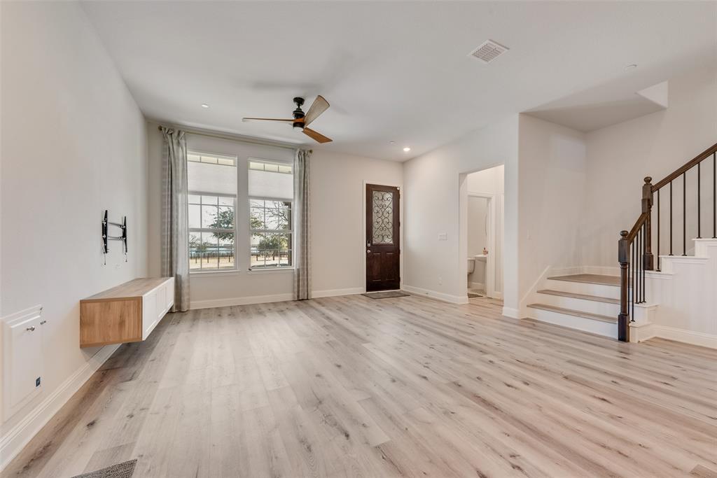 7617 Sunset Boulevard Rowlett, TX 75088 - Photo 9 of 21 Unfurnished living room featuring light wood-style floors, stairs, recessed lighting, and a ceiling fan