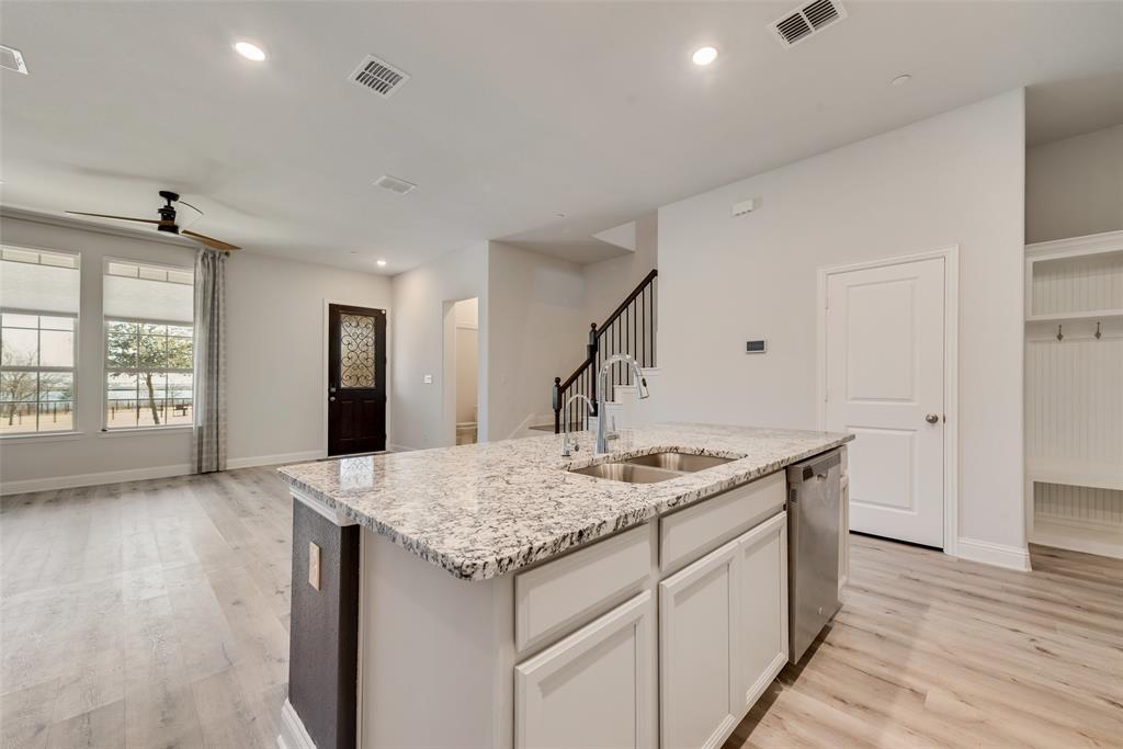 7617 Sunset Boulevard Rowlett, TX 75088 - Photo 10 of 21 Kitchen featuring white cabinets, ceiling fan, light wood-style floors, light stone countertops, and recessed lighting