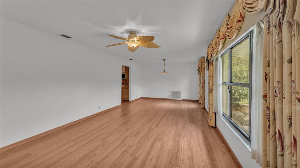 9240 Moore Road Lakeland, FL 33809 - Photo 19 of 61 a view of a hallway with wooden floor and a chandelier