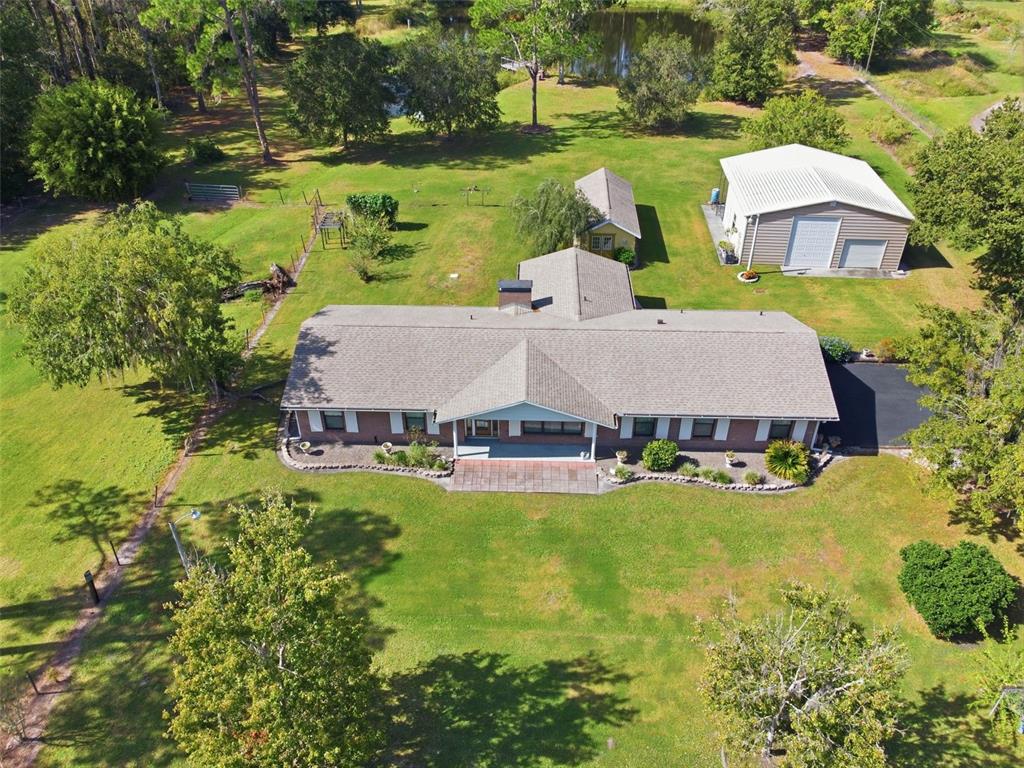 9240 Moore Road Lakeland, FL 33809 - Photo 2 of 61 an aerial view of a house with swimming pool garden and patio
