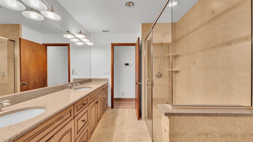 9240 Moore Road Lakeland, FL 33809 - Photo 26 of 61 a bathroom with a double vanity sink and mirror