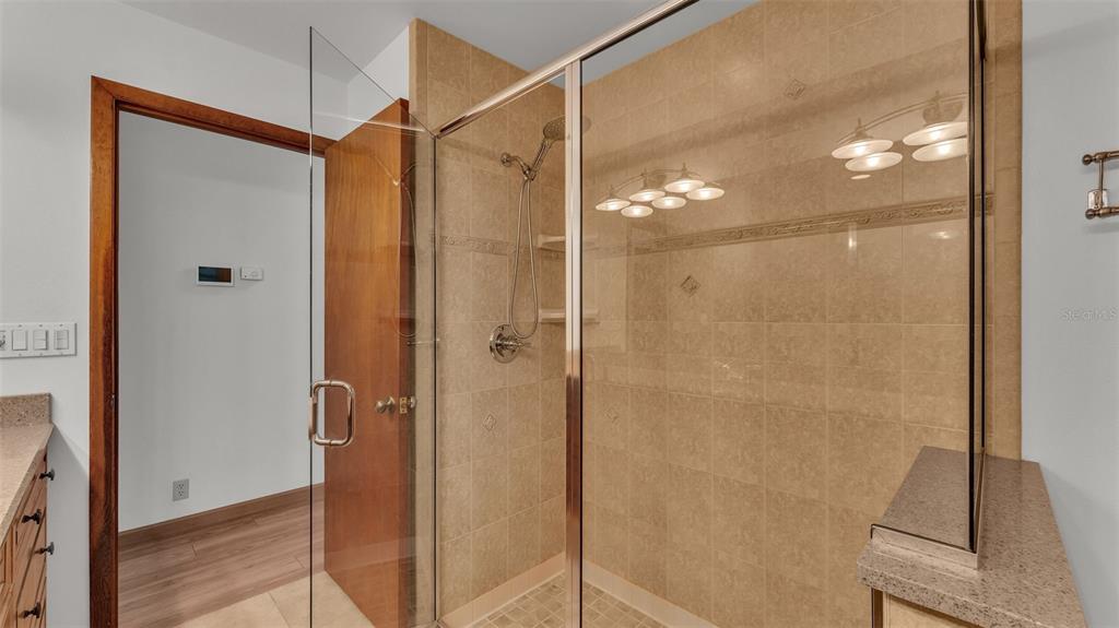 9240 Moore Road Lakeland, FL 33809 - Photo 27 of 61 a bathroom with a glass shower door