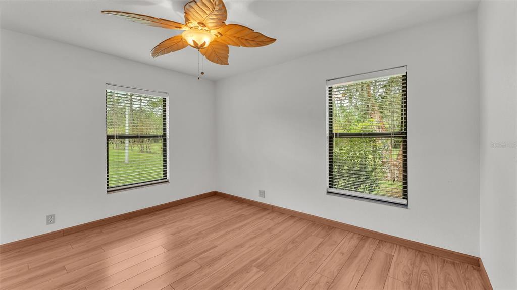 9240 Moore Road Lakeland, FL 33809 - Photo 30 of 61 a view of an empty room with wooden floor and a window