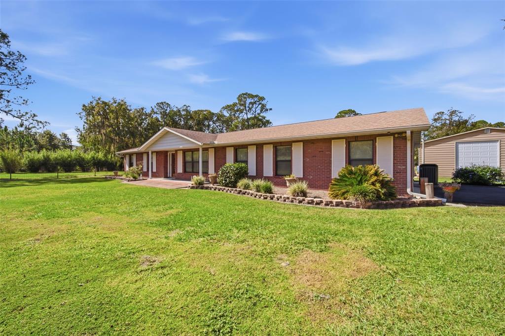 9240 Moore Road Lakeland, FL 33809 - Photo 41 of 61 a front view of a house with garden